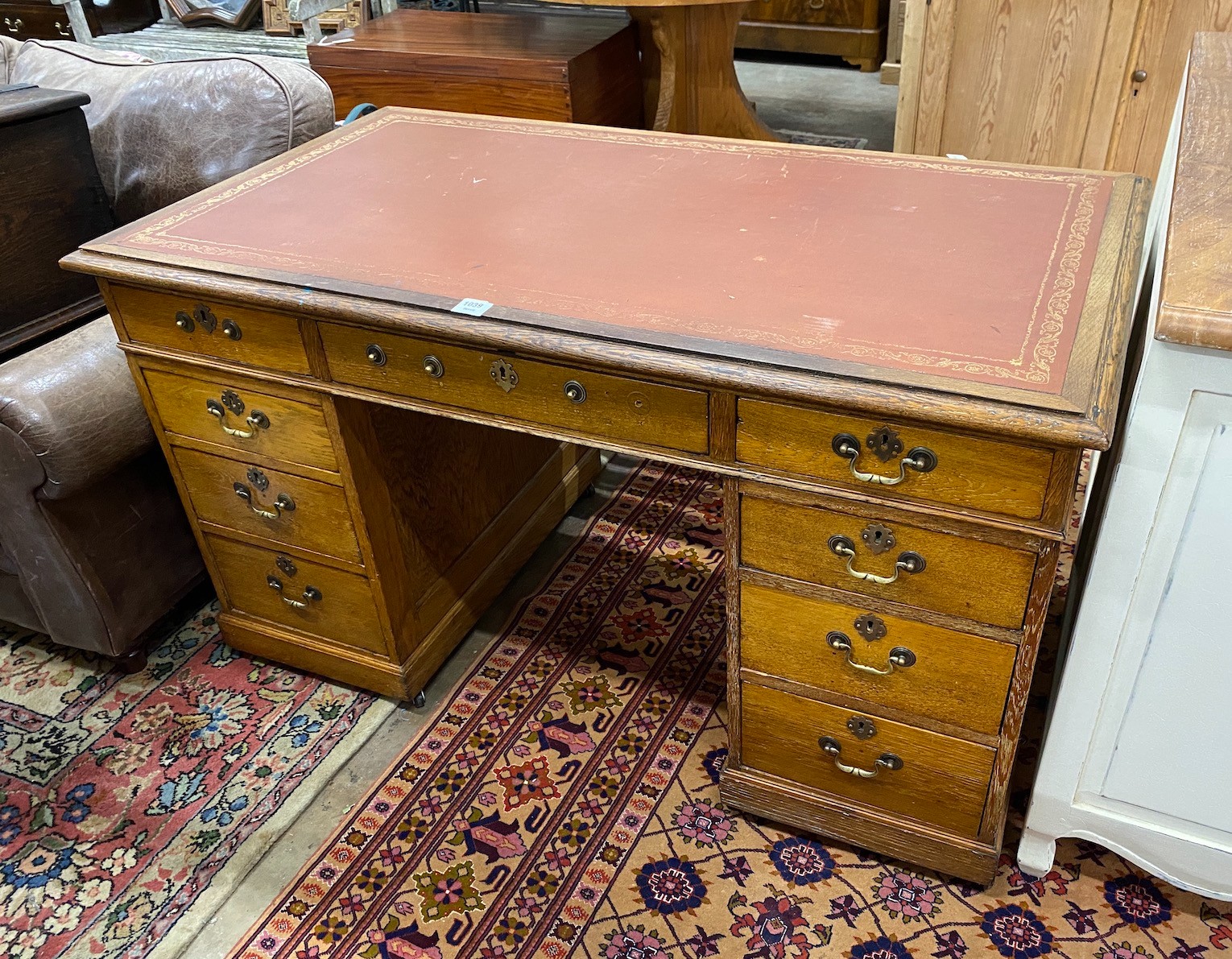 An Edwardian oak pedestal desk, width 138cm